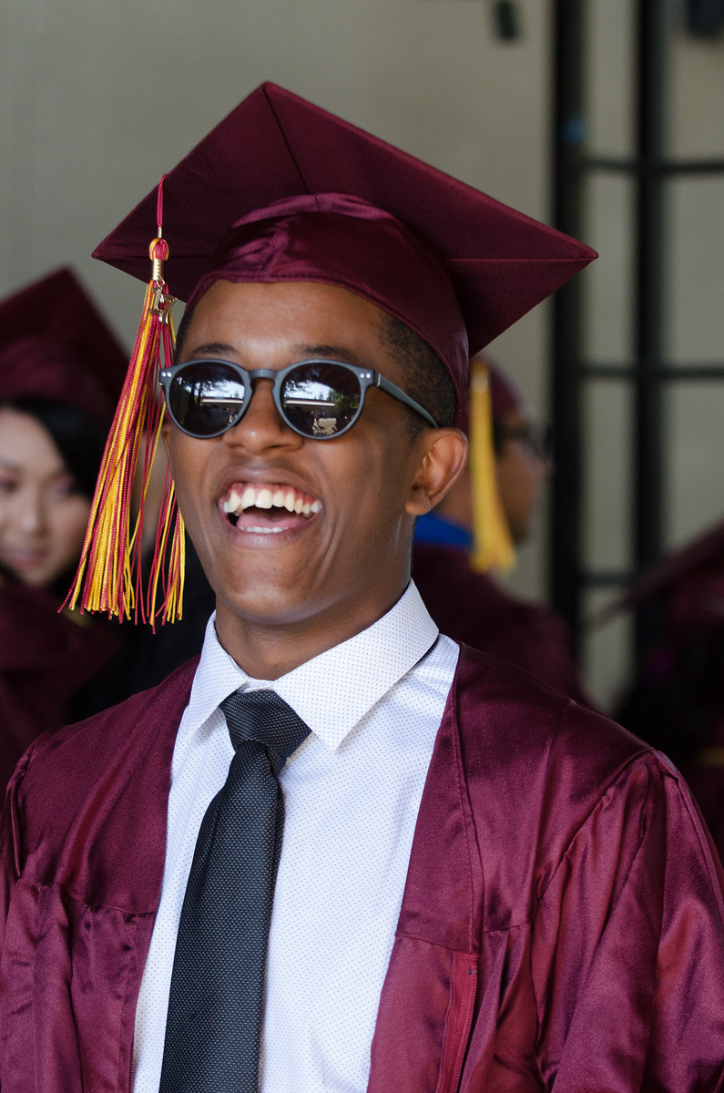 young grad guy with sunglasses