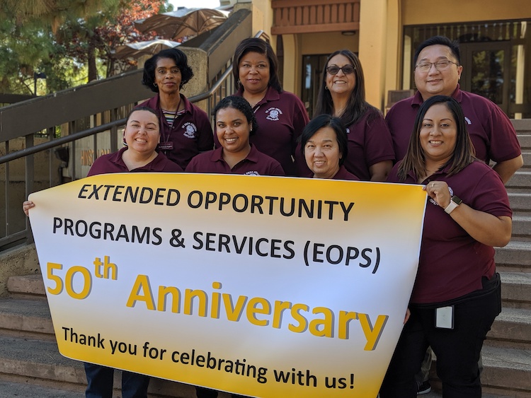 EOPS staff holding sign for 50th anniversary