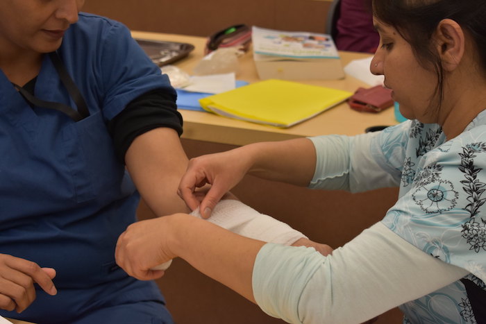 students practicing with bandages