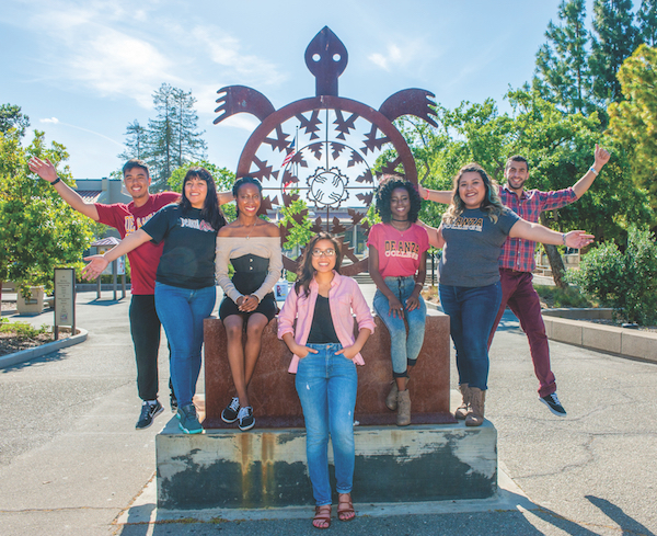 students with turtle sculpture