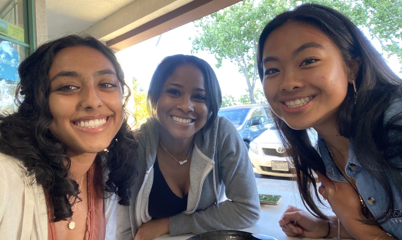 three young women smiling