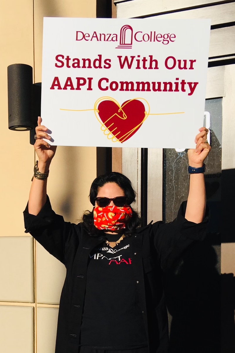 Karen Chow with sign: De Anza College Stands With Our AAPI Community
