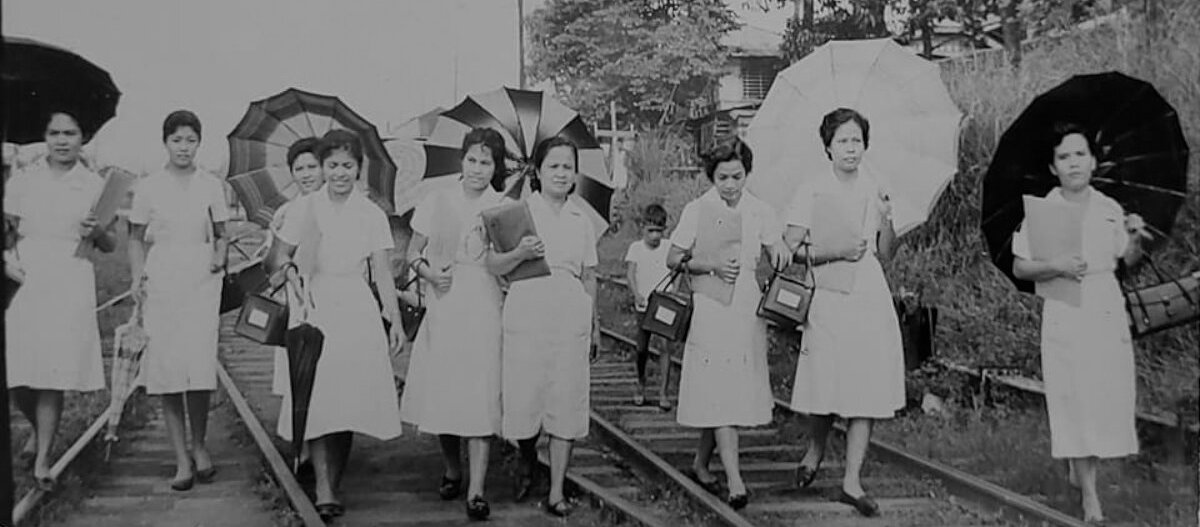 black and white photo of nurses walking outside