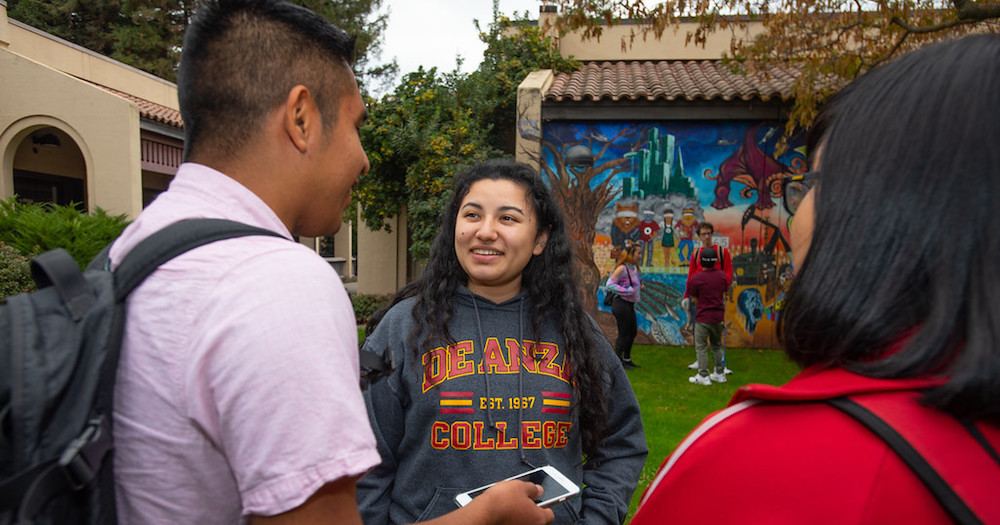 two students talking in art quad