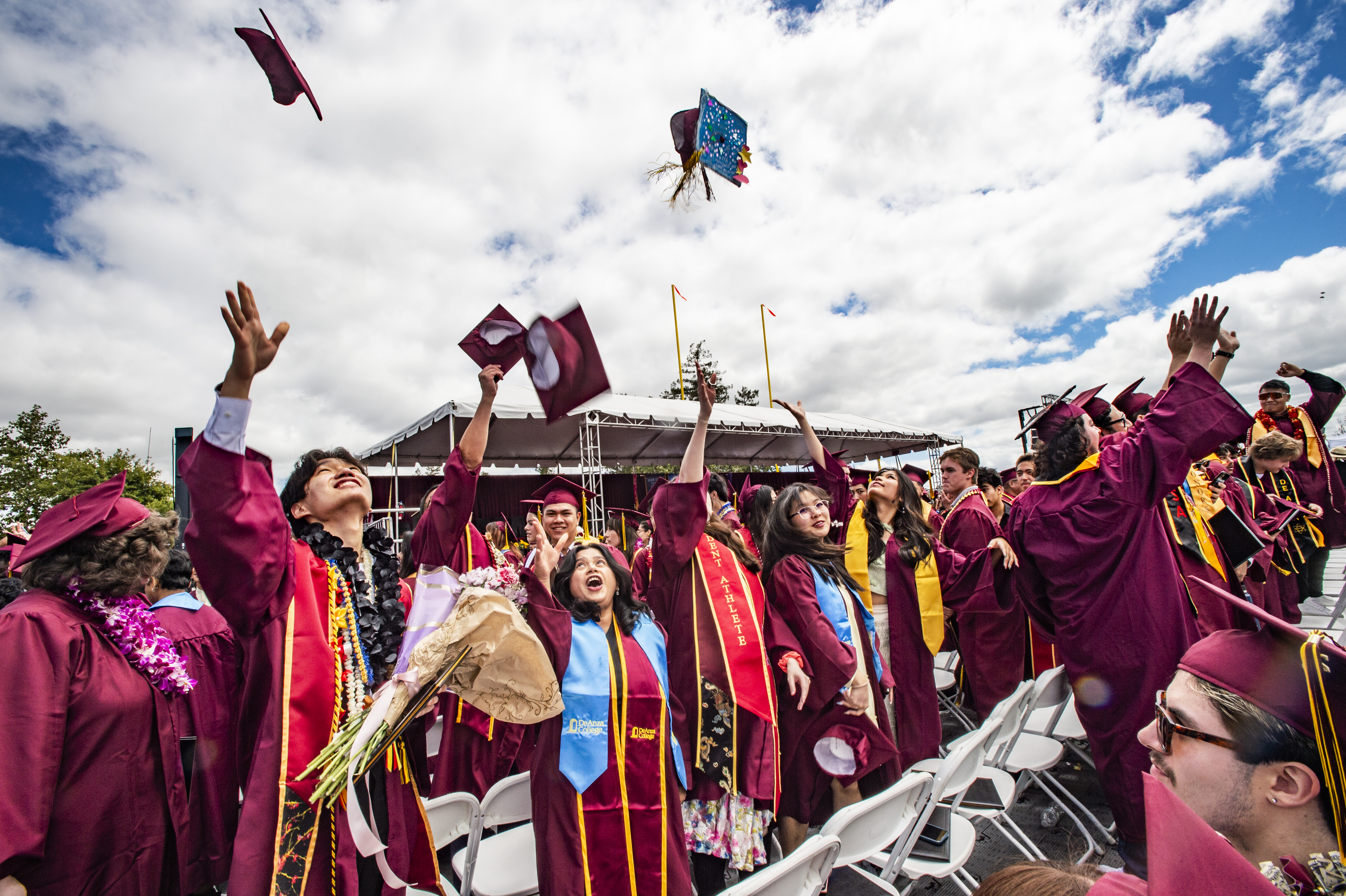 Grads toss their caps in the air