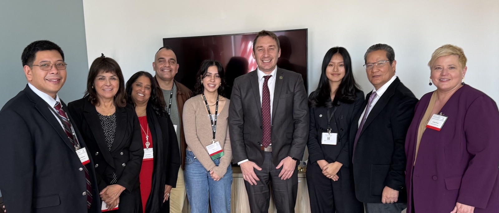 college and district leaders stand with Assembly Member Patrick Ahrens around De Anza rug