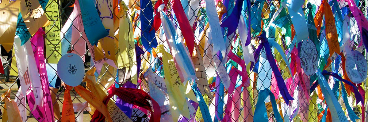 colorful ribbons on a fence